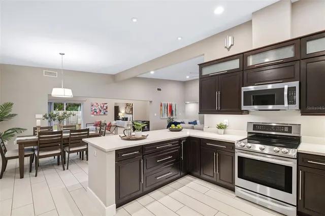 a kitchen with a sink stove and microwave