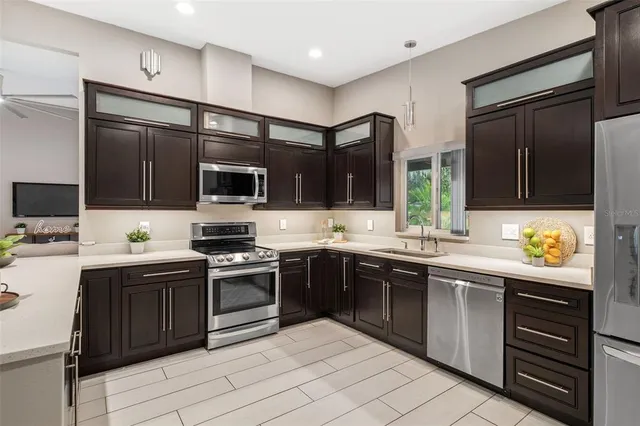 a kitchen with stainless steel appliances granite countertop a sink and stove top oven