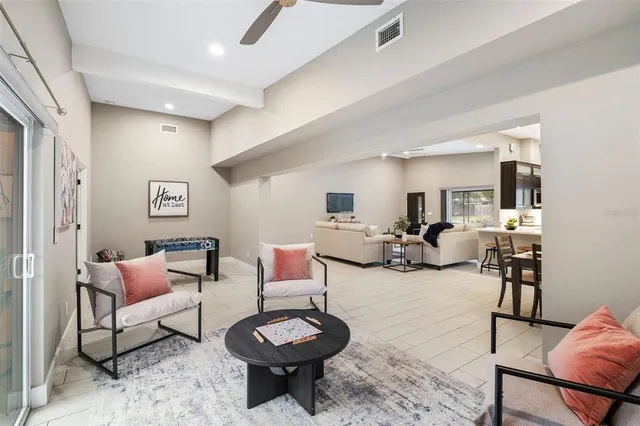 a living room with furniture a rug and a painting on the wall