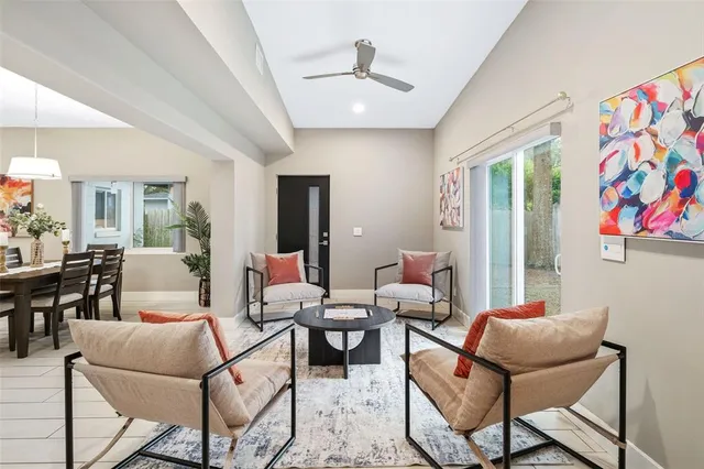 a living room with furniture and a painting on the wall