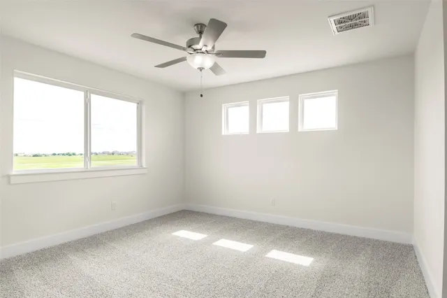 an empty room with a ceiling fan and a window