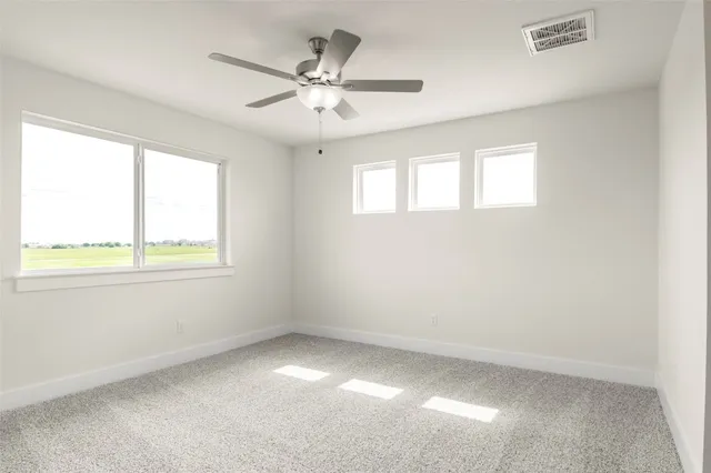 an empty room with a ceiling fan and a window