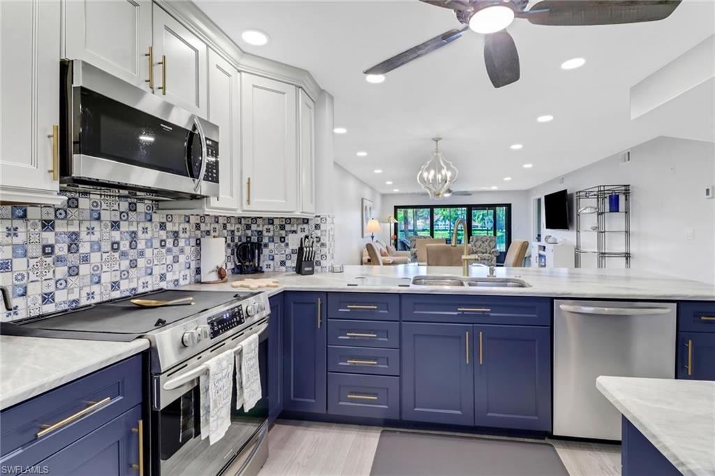 a kitchen with stainless steel appliances granite countertop a sink and a stove