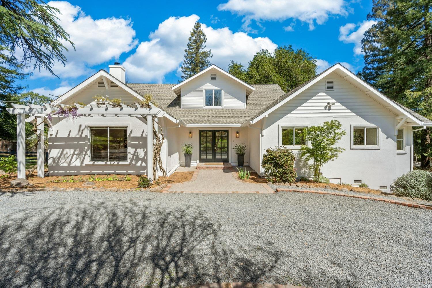 a view of a house with a patio and a yard