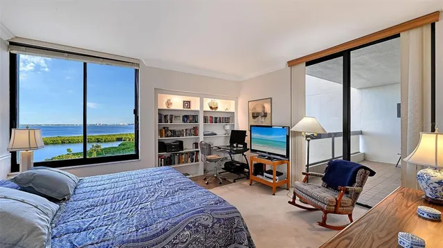 a bedroom with two beds and a lamp on dresser