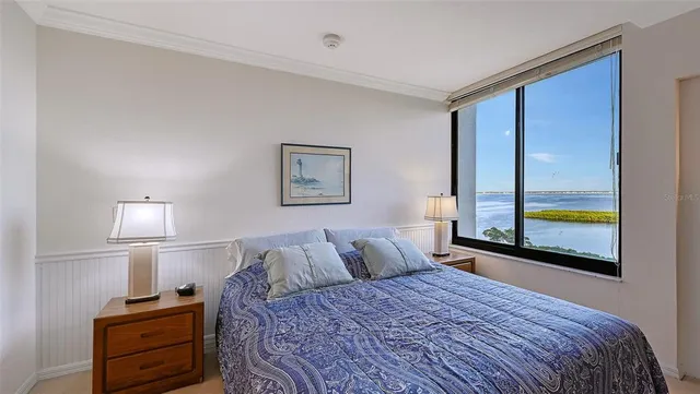 a bedroom with a bed and a lamp