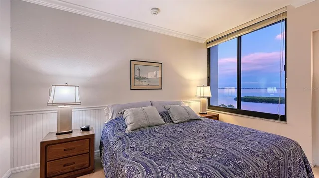 a bathroom with a granite countertop sink a toilet a mirror and shower