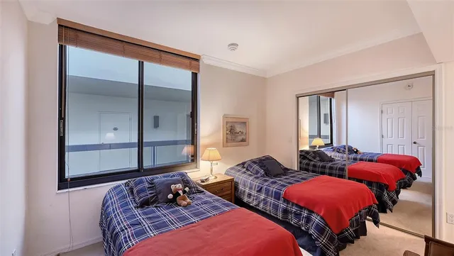a living room with patio furniture and a potted plant