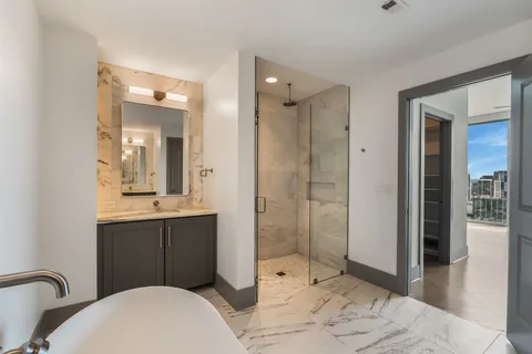a bathroom with a granite countertop sink a toilet and a mirror