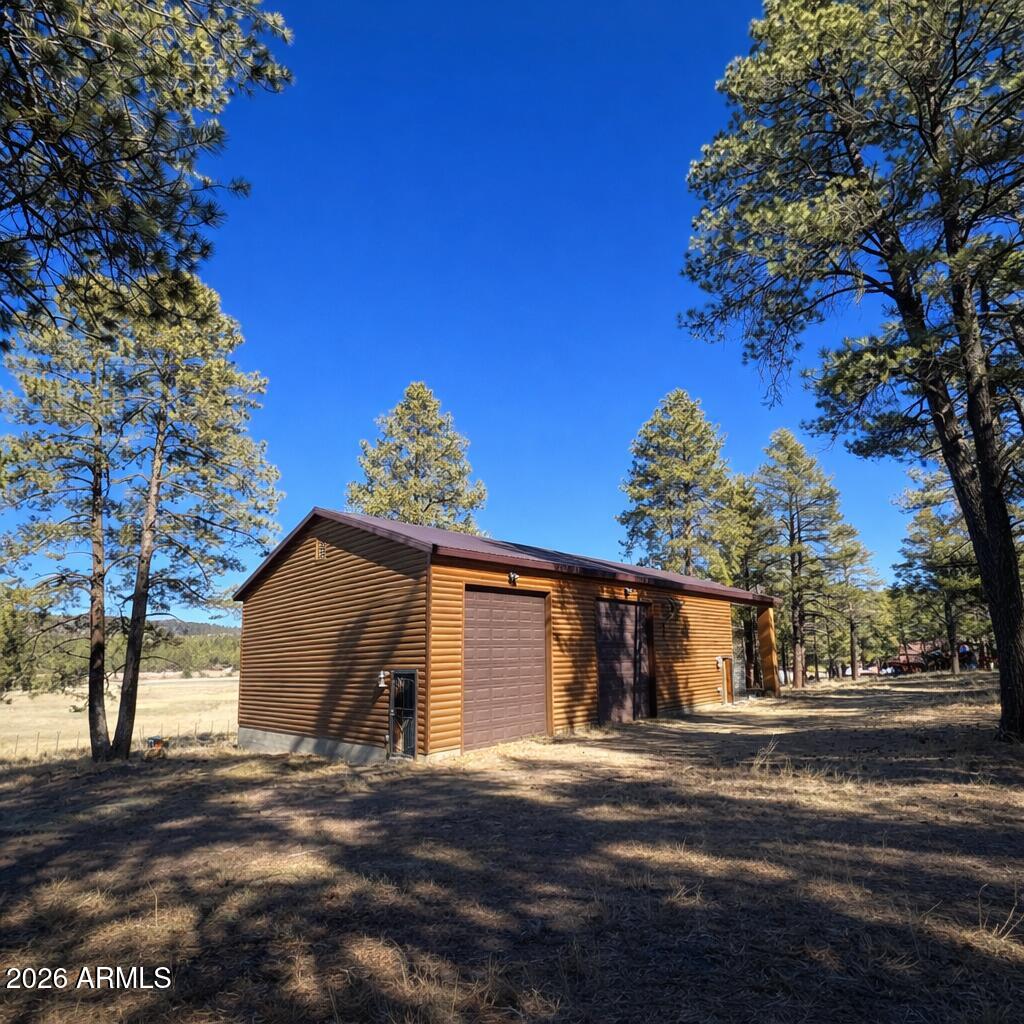 3 County Road Alpine, AZ 85920 - Photo 36 of 39 Wooden garage in the forest clearing