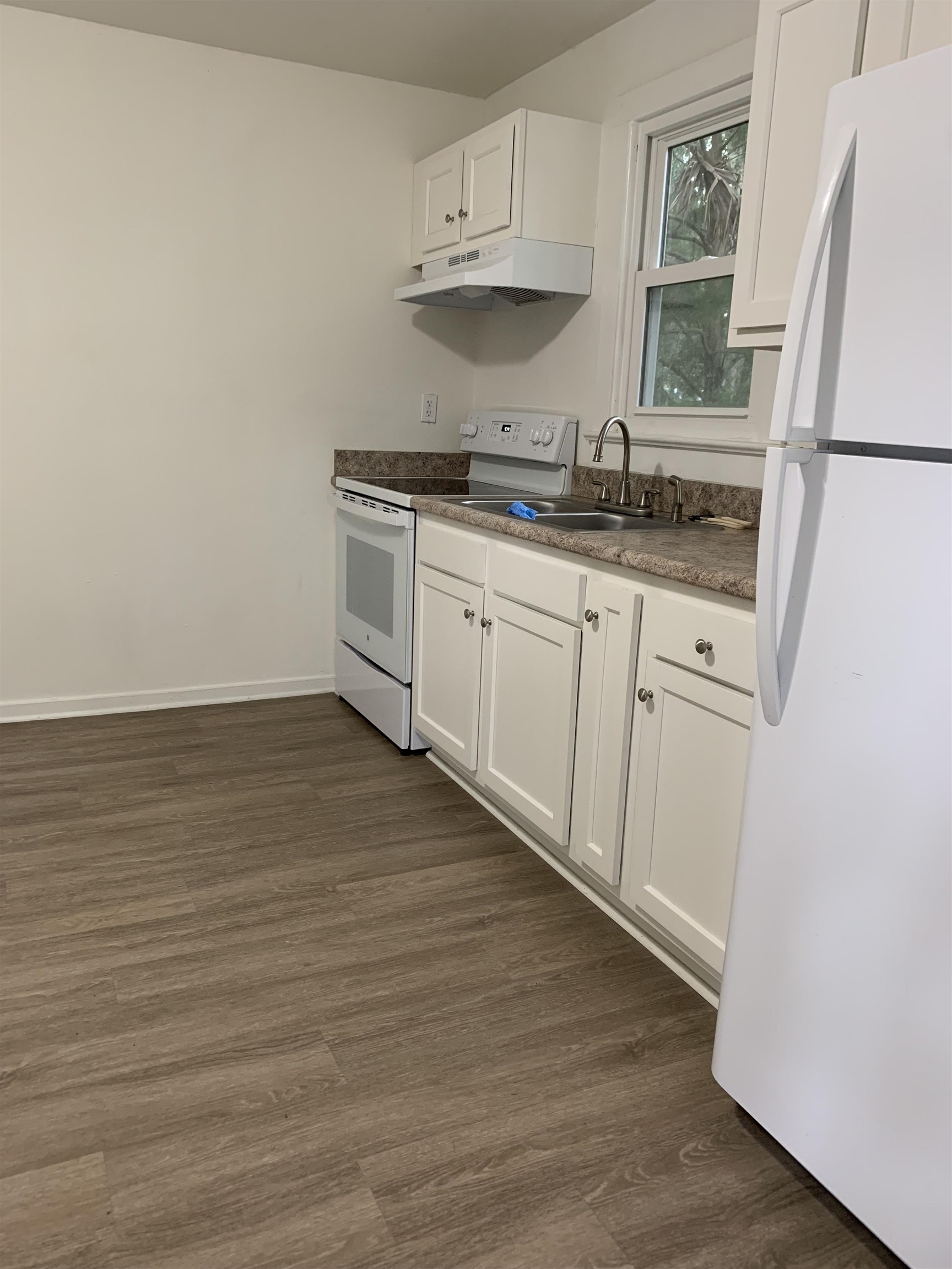 560 Christopher Street, Unit A St. Augustine, FL 32084 - Photo 4 of 8 a kitchen with stainless steel appliances a sink a stove a refrigerator and cabinets