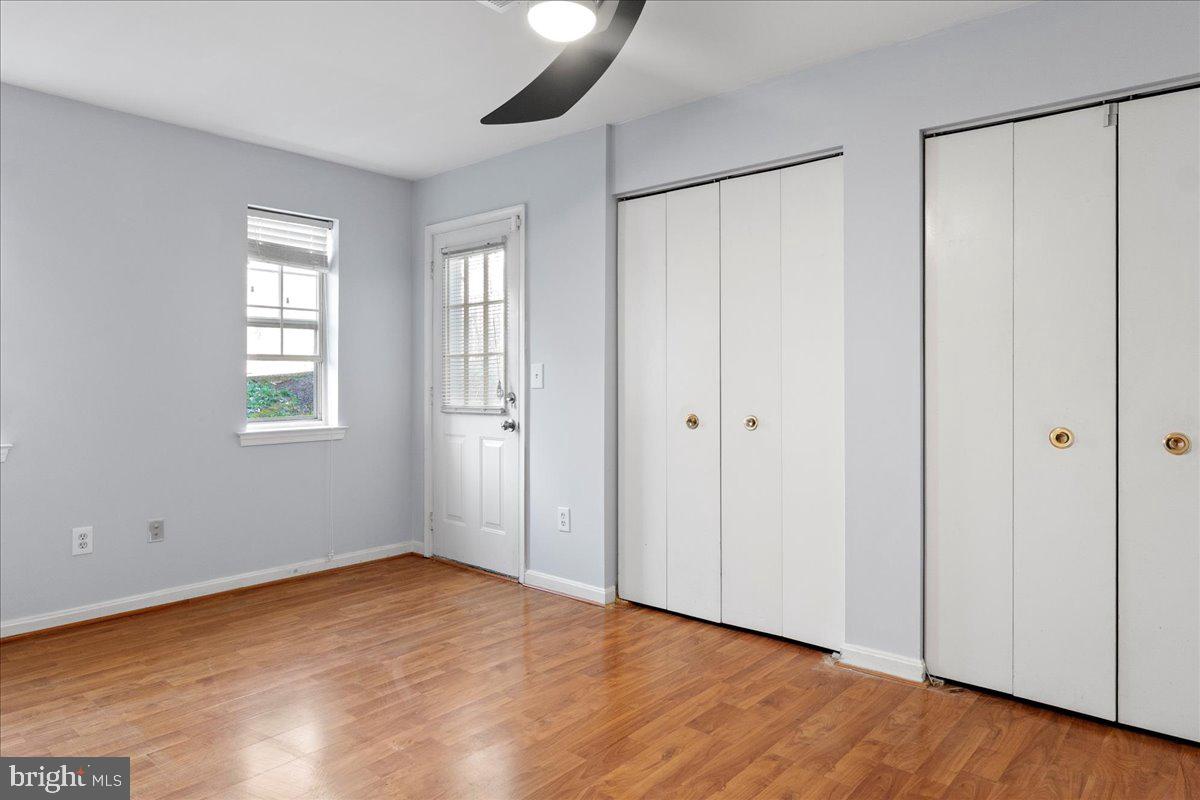 14903 Rydell Road, Unit 104 Centreville, VA 20121 - Photo 7 of 12 a view of an empty room with wooden floor and a window