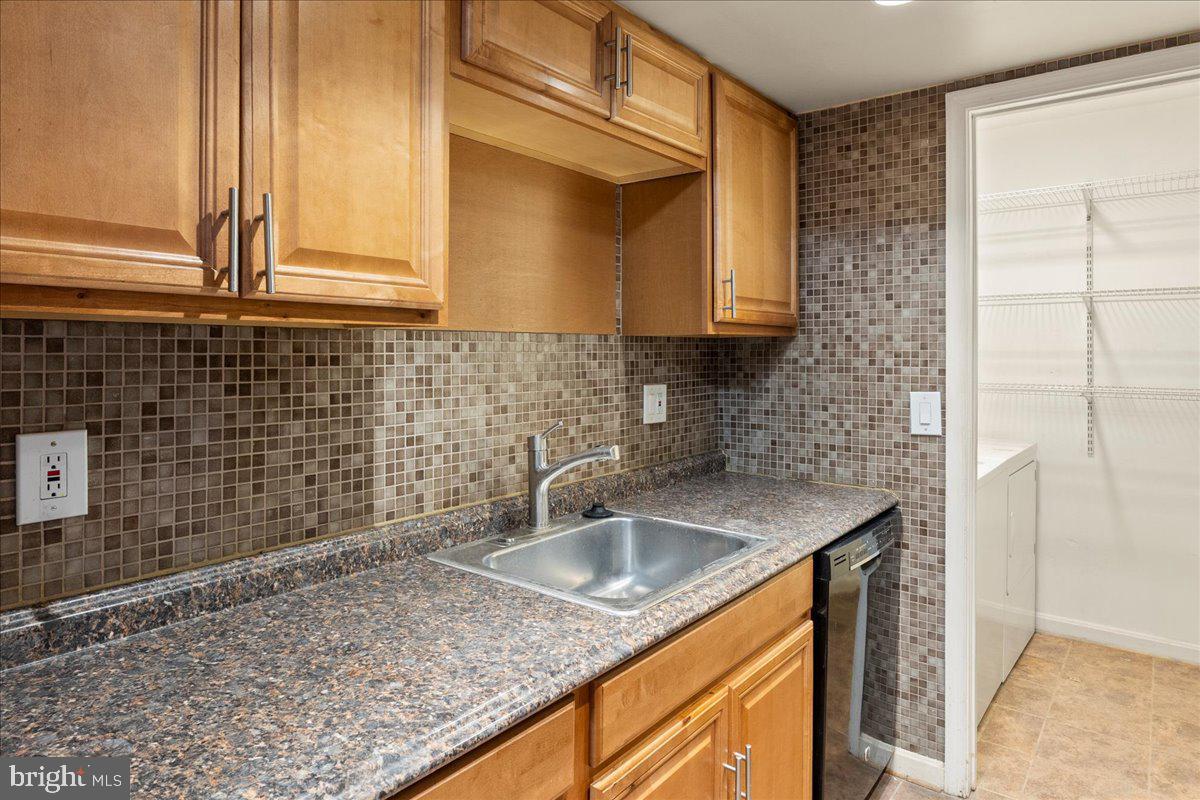 14903 Rydell Road, Unit 104 Centreville, VA 20121 - Photo 10 of 12 a kitchen with a sink a cabinets and window