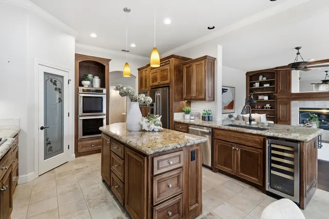 a kitchen with stainless steel appliances granite countertop a stove and a sink