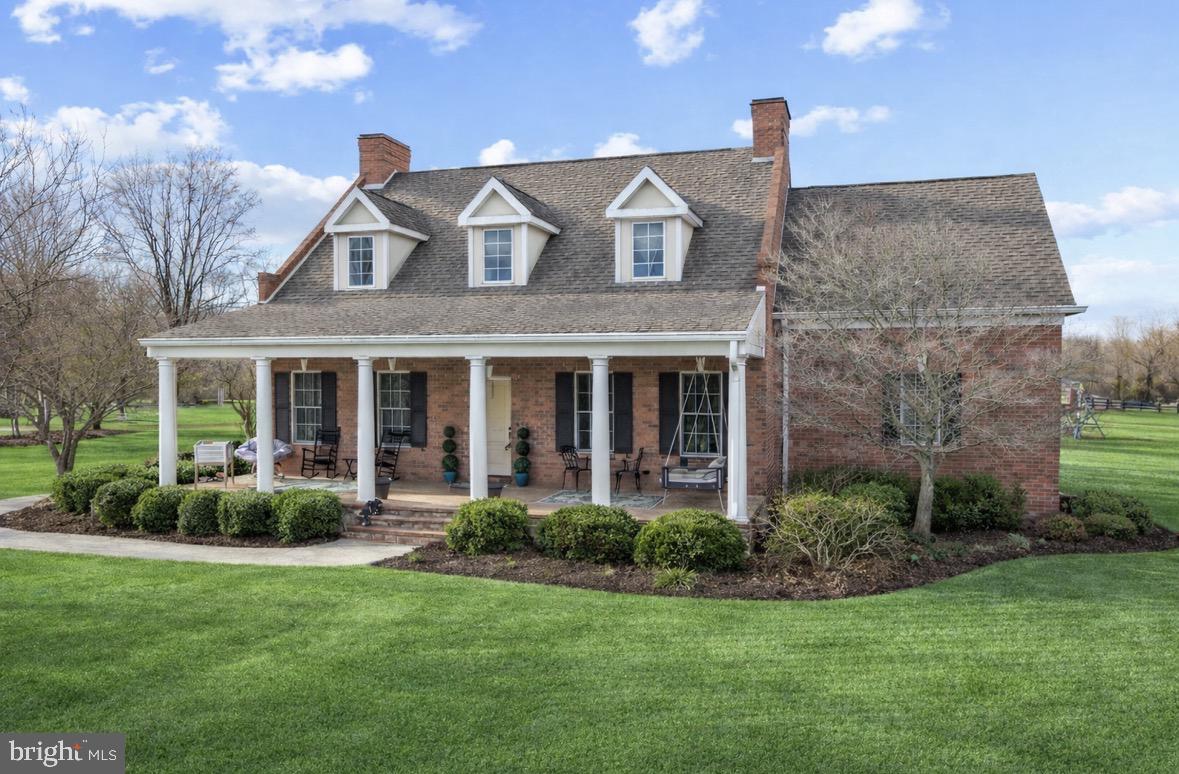 a front view of a house with garden and porch