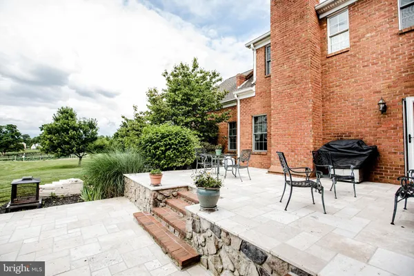 a kitchen with stainless steel appliances granite countertop table chairs and wooden floor