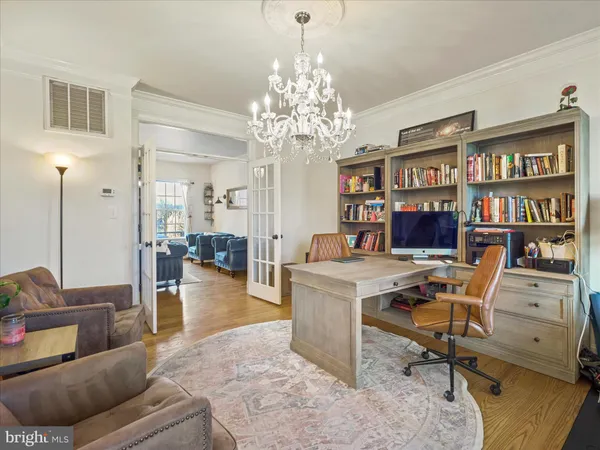 a bedroom with furniture and a chandelier