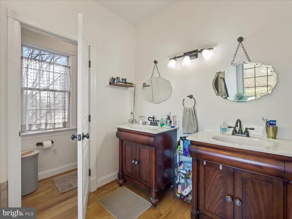 a bathroom with a sink a toilet and a window