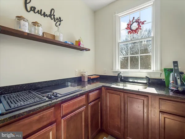 a bedroom with a large bed chandelier and a window