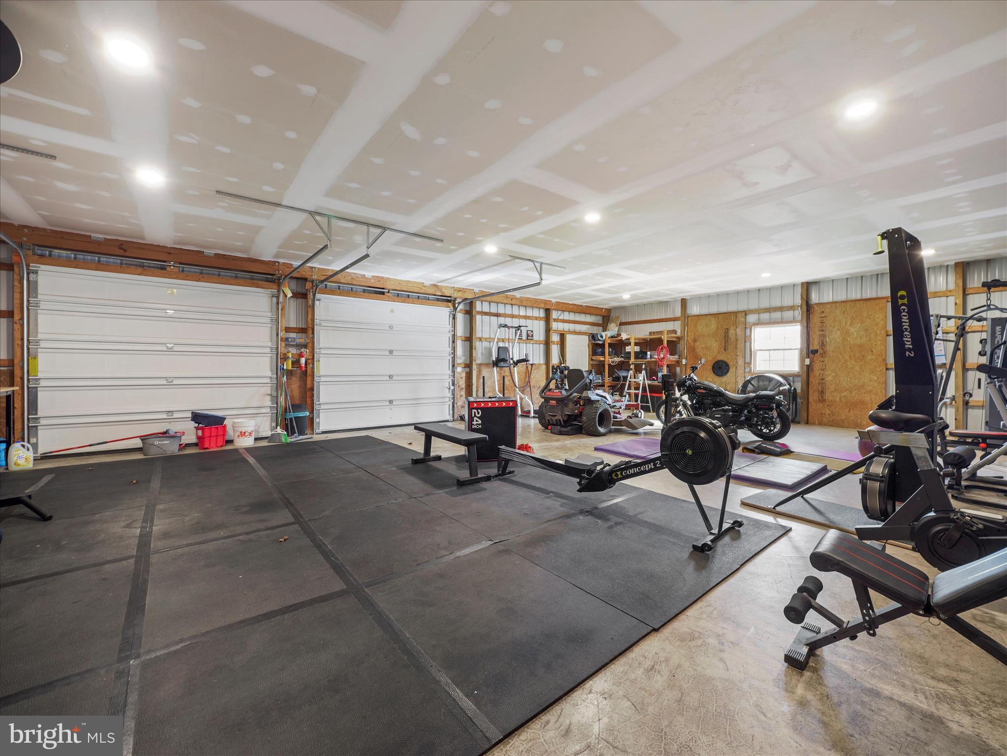 126 Heritage Knoll Ln Summit Point Summit Point, WV 25446 - Photo 64 of 64 a view of a room with gym equipment and windows