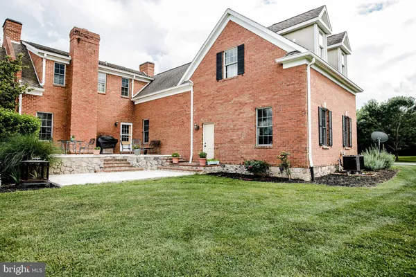 an aerial view of a house with a yard and trees