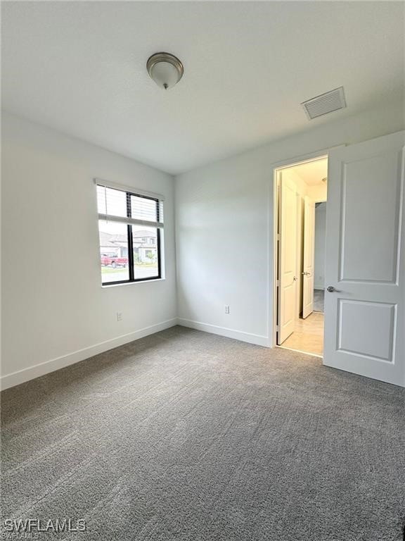 5221 Marano Drive Immokalee, FL 34142 - Photo 11 of 40 an empty room with windows