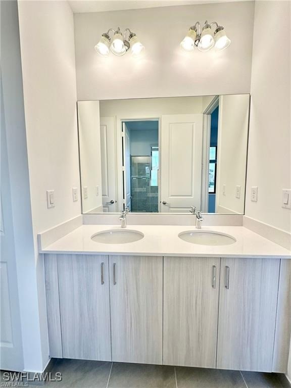5221 Marano Drive Immokalee, FL 34142 - Photo 12 of 40 a bathroom with a double vanity sink and a mirror