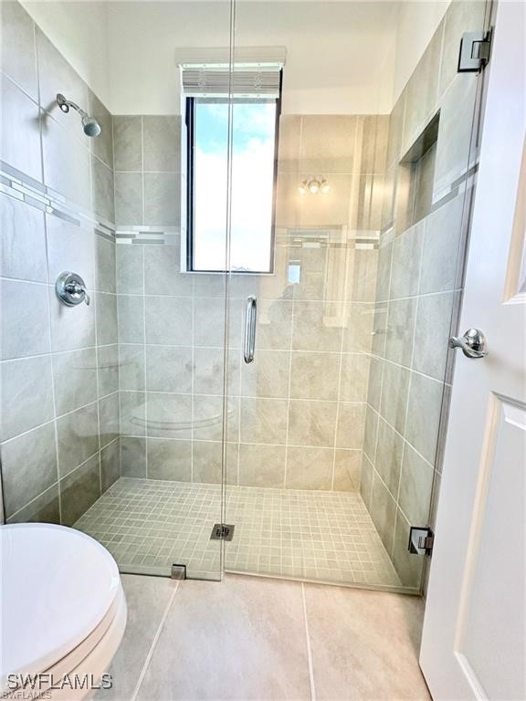 5221 Marano Drive Immokalee, FL 34142 - Photo 13 of 40 a bathroom with a shower and a toilet
