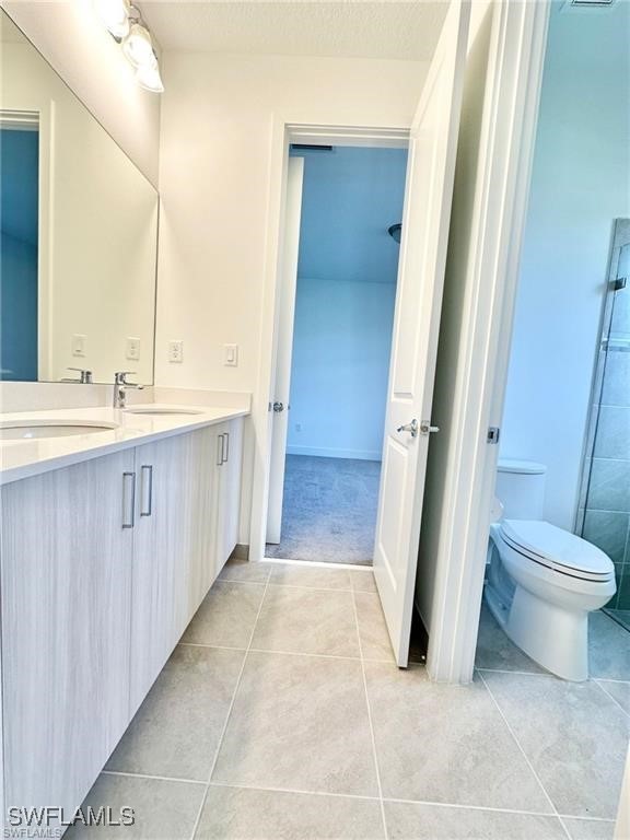 5221 Marano Drive Immokalee, FL 34142 - Photo 16 of 40 a bathroom with a sink a toilet and a mirror