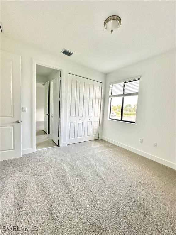 5221 Marano Drive Immokalee, FL 34142 - Photo 17 of 40 an empty room with windows