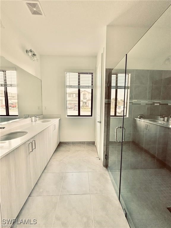 5221 Marano Drive Immokalee, FL 34142 - Photo 19 of 40 a bathroom with a tub sink and mirror