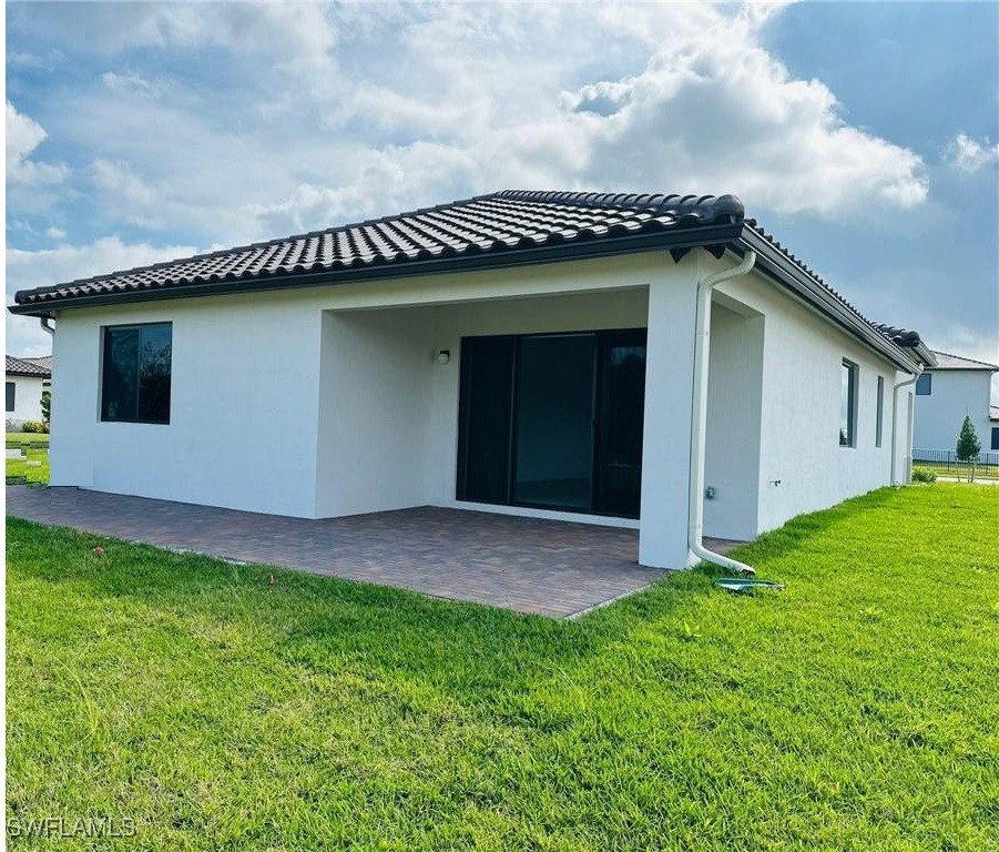 5221 Marano Drive Immokalee, FL 34142 - Photo 24 of 40 a view of a house with a yard