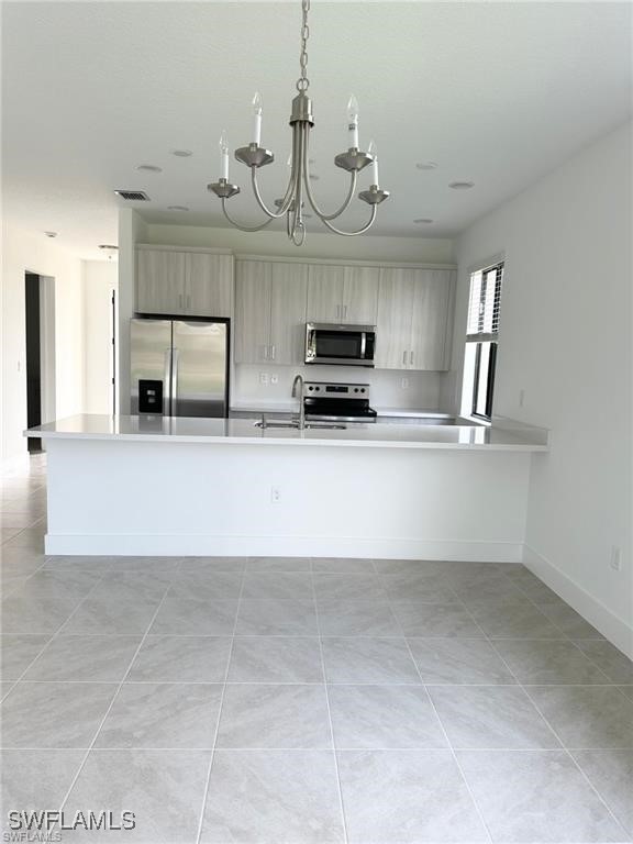 5221 Marano Drive Immokalee, FL 34142 - Photo 3 of 40 a view of a kitchen with a sink and dishwasher a kitchen island with wooden floor