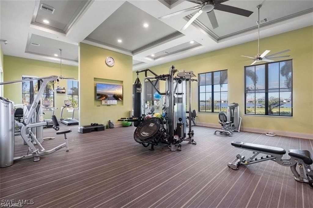5221 Marano Drive Immokalee, FL 34142 - Photo 32 of 40 a living room with furniture a window and gym equipment