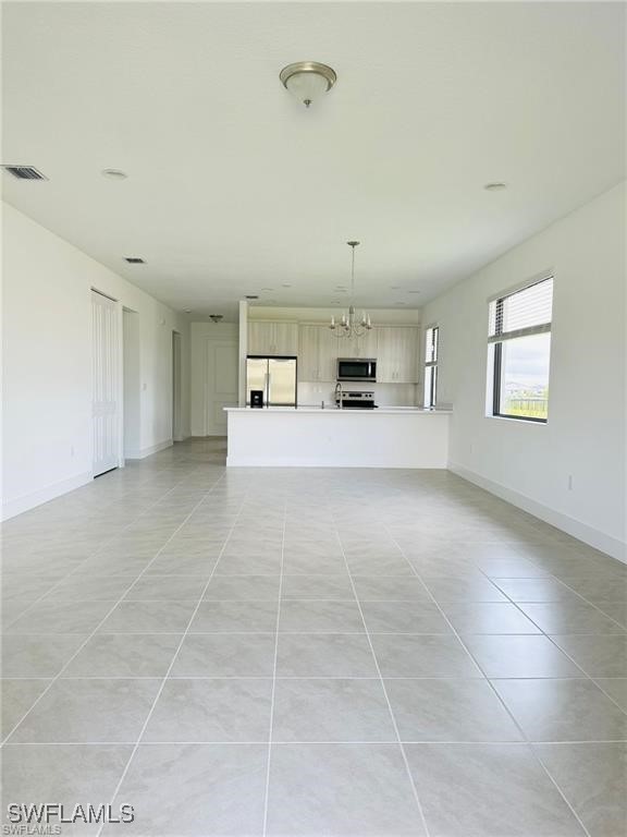 5221 Marano Drive Immokalee, FL 34142 - Photo 9 of 40 a large white room with kitchen and windows