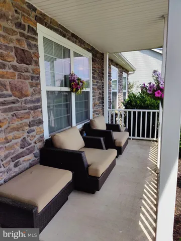 a living room with furniture and flowers