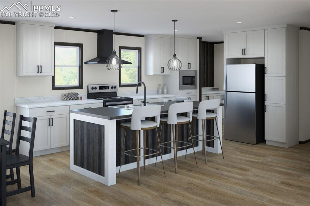5557 Sengbeil Road Yoder, CO 80864 - Photo 2 of 2 a kitchen with stainless steel appliances a stove a sink refrigerator and a fireplace