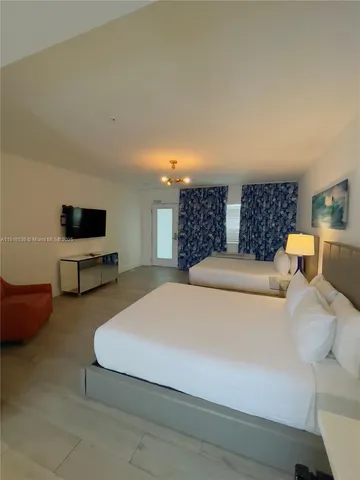 a spacious bedroom with a bed and a couch