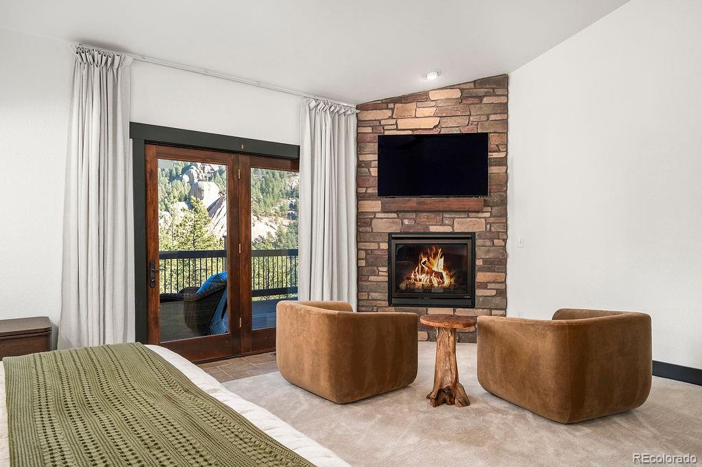 16654 South 7th Street Pine, CO 80470 - Photo 21 of 50 a living room with furniture a flat screen tv and a fireplace
