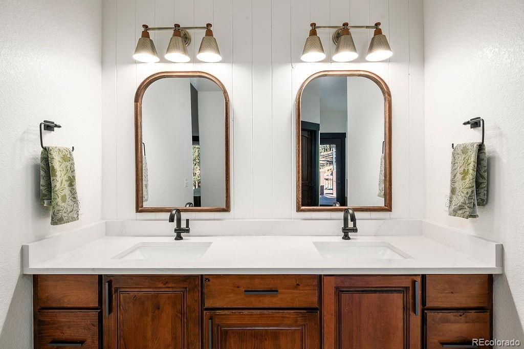 16654 South 7th Street Pine, CO 80470 - Photo 22 of 50 a bathroom with a double vanity sink and a mirror