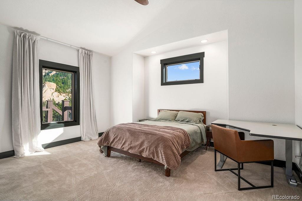 16654 South 7th Street Pine, CO 80470 - Photo 25 of 50 a bedroom with a bed and a painting on the wall