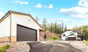 16654 South 7th Street Pine, CO 80470 - Photo 42 of 50 a view of a house with a yard