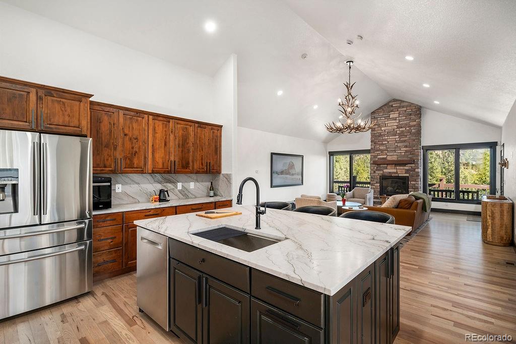 16654 South 7th Street Pine, CO 80470 - Photo 8 of 50 a kitchen with stainless steel appliances granite countertop a sink refrigerator and cabinets