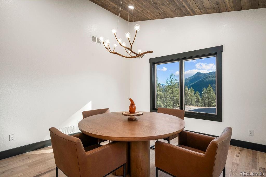 16654 South 7th Street Pine, CO 80470 - Photo 10 of 50 a dining room with furniture and wooden floor