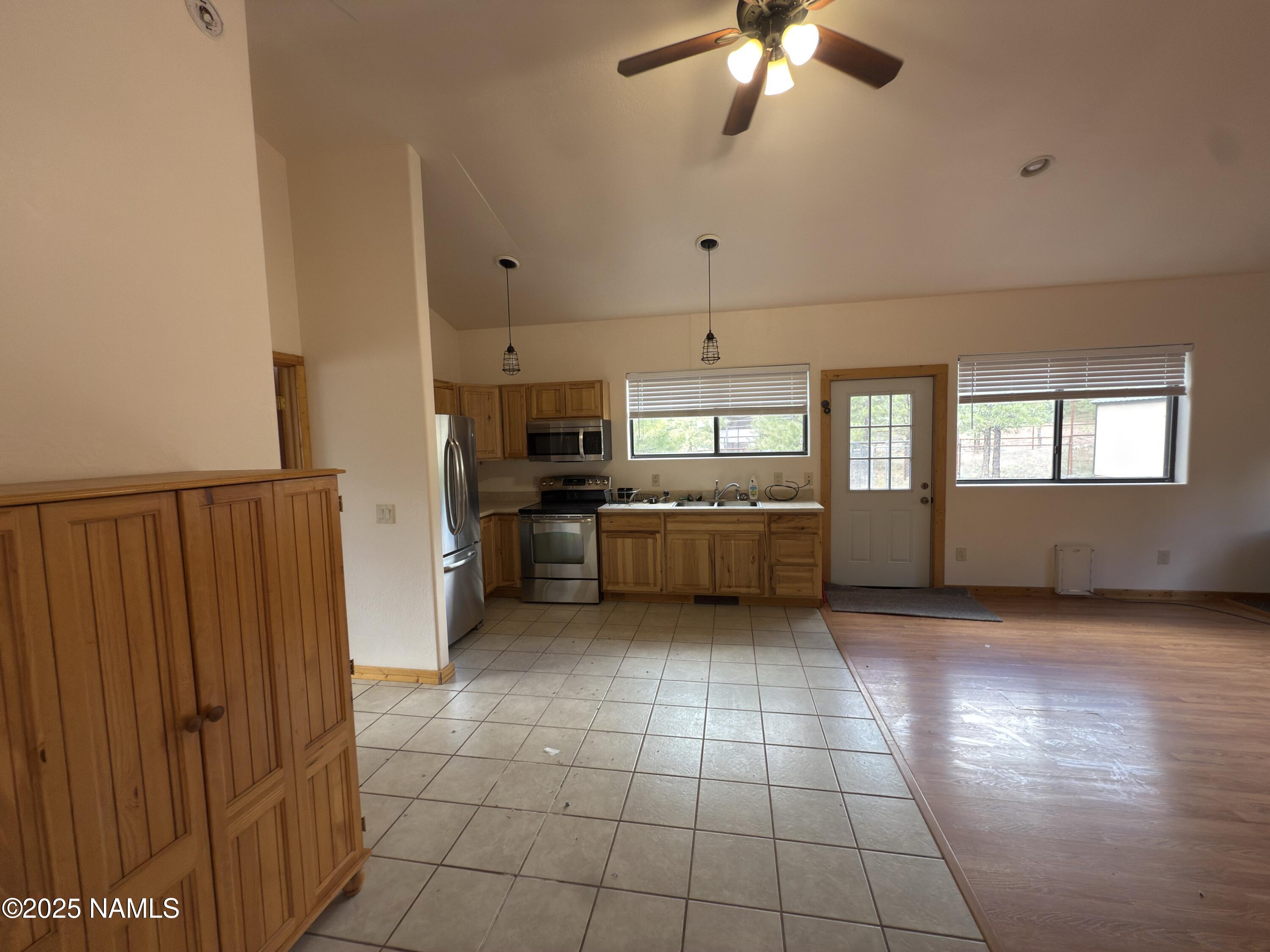 7261 East Long Bow Drive Williams, AZ 86046 - Photo 11 of 43 a view of a kitchen with microwave and cabinets