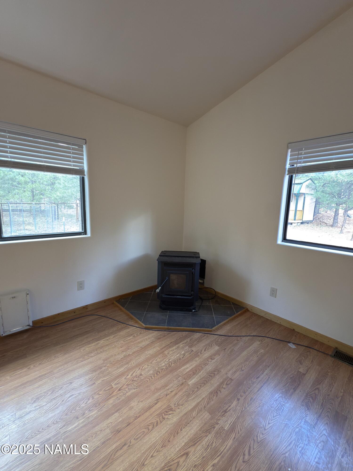 7261 East Long Bow Drive Williams, AZ 86046 - Photo 12 of 43 a view of an empty room with wooden floor and a window