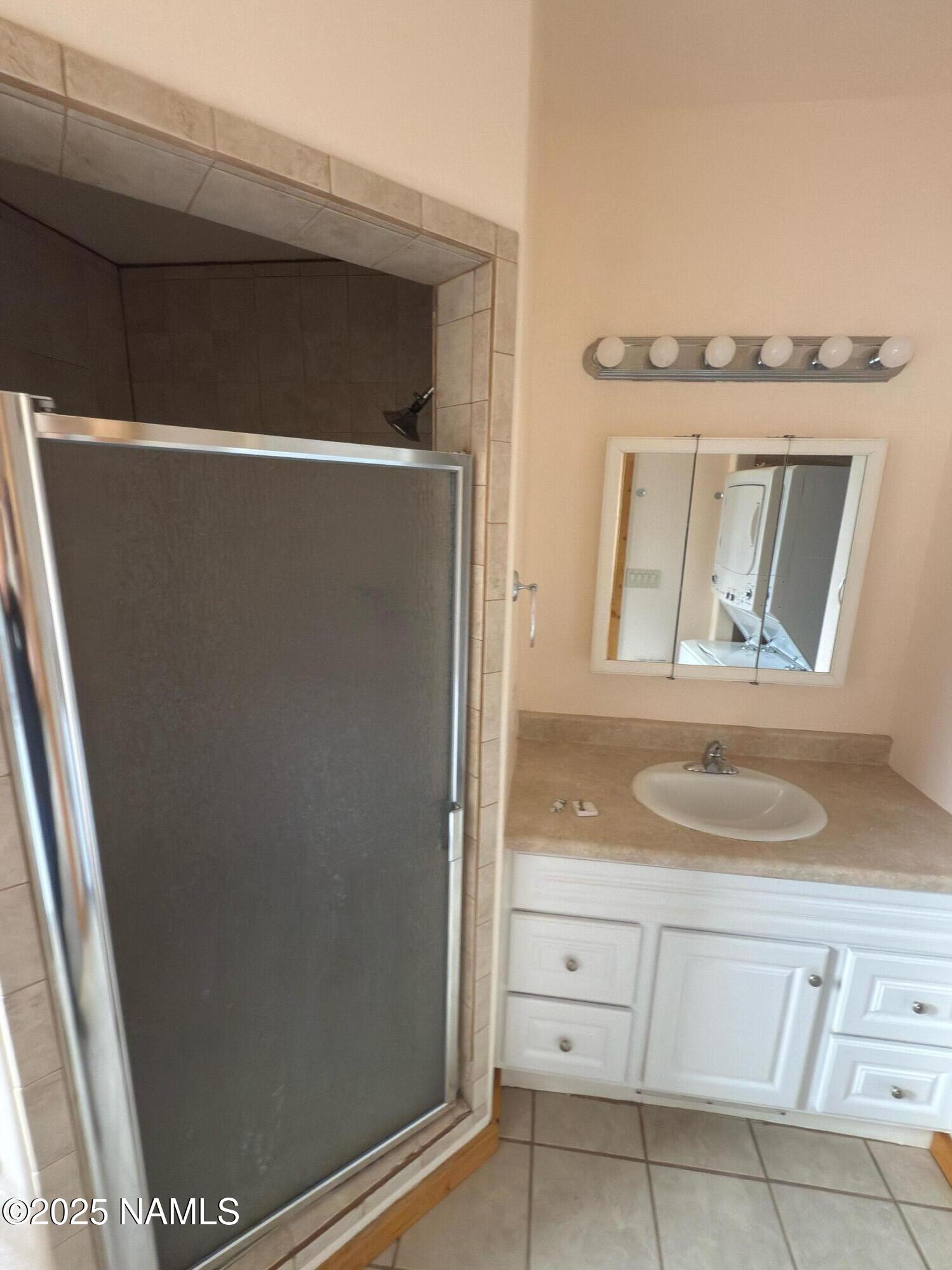 7261 East Long Bow Drive Williams, AZ 86046 - Photo 13 of 43 a bathroom with a granite countertop sink and a mirror