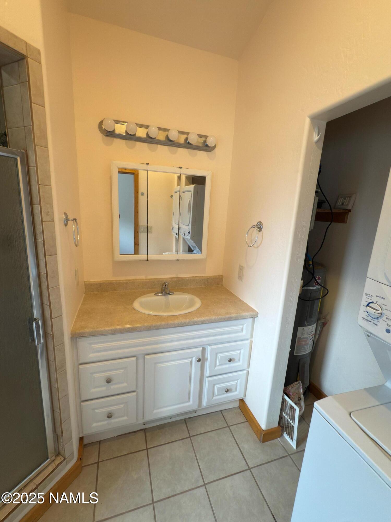 7261 East Long Bow Drive Williams, AZ 86046 - Photo 15 of 43 a bathroom with a granite countertop sink and a mirror
