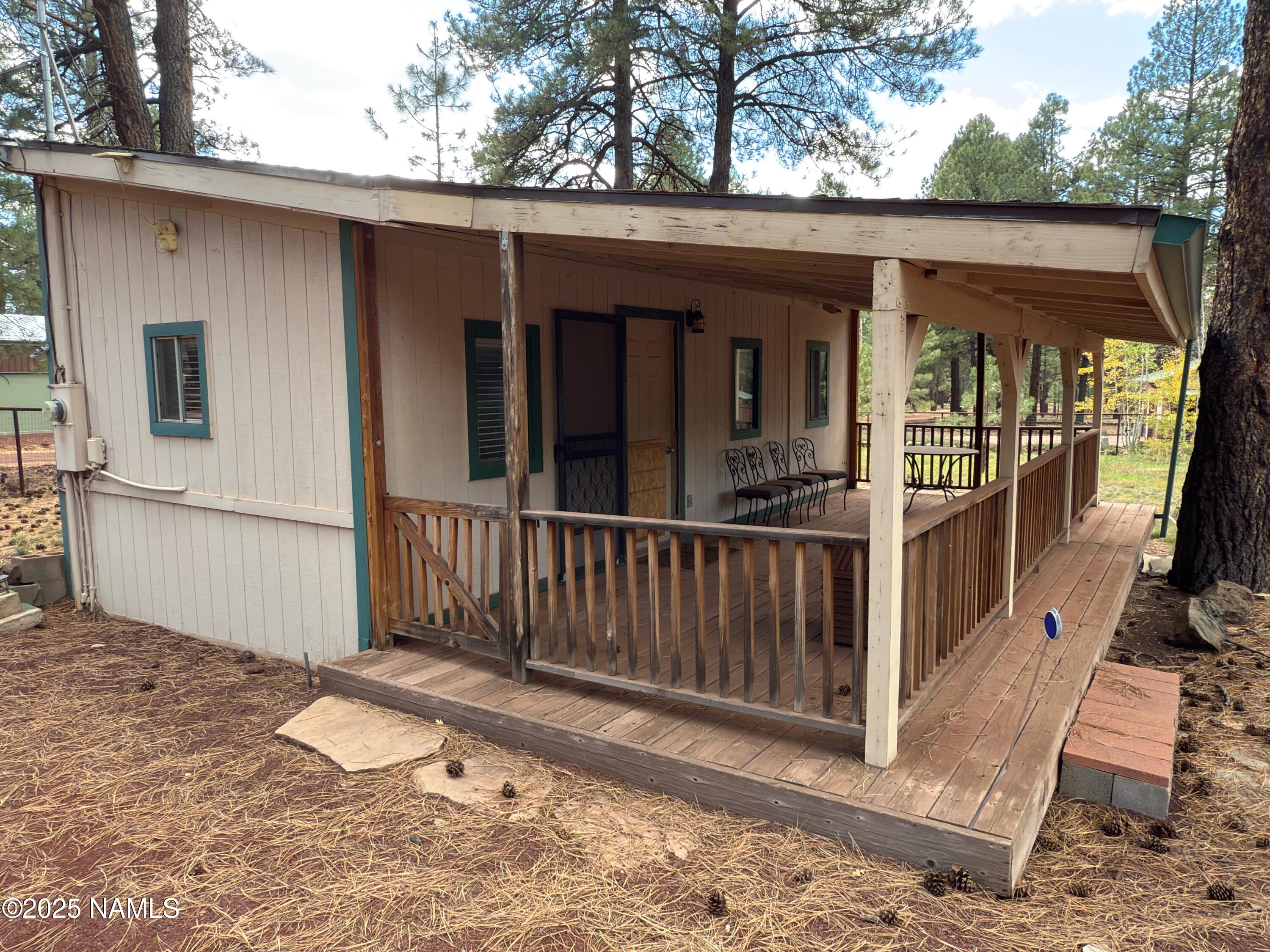 7261 East Long Bow Drive Williams, AZ 86046 - Photo 17 of 43 a view of a house with a wooden fence