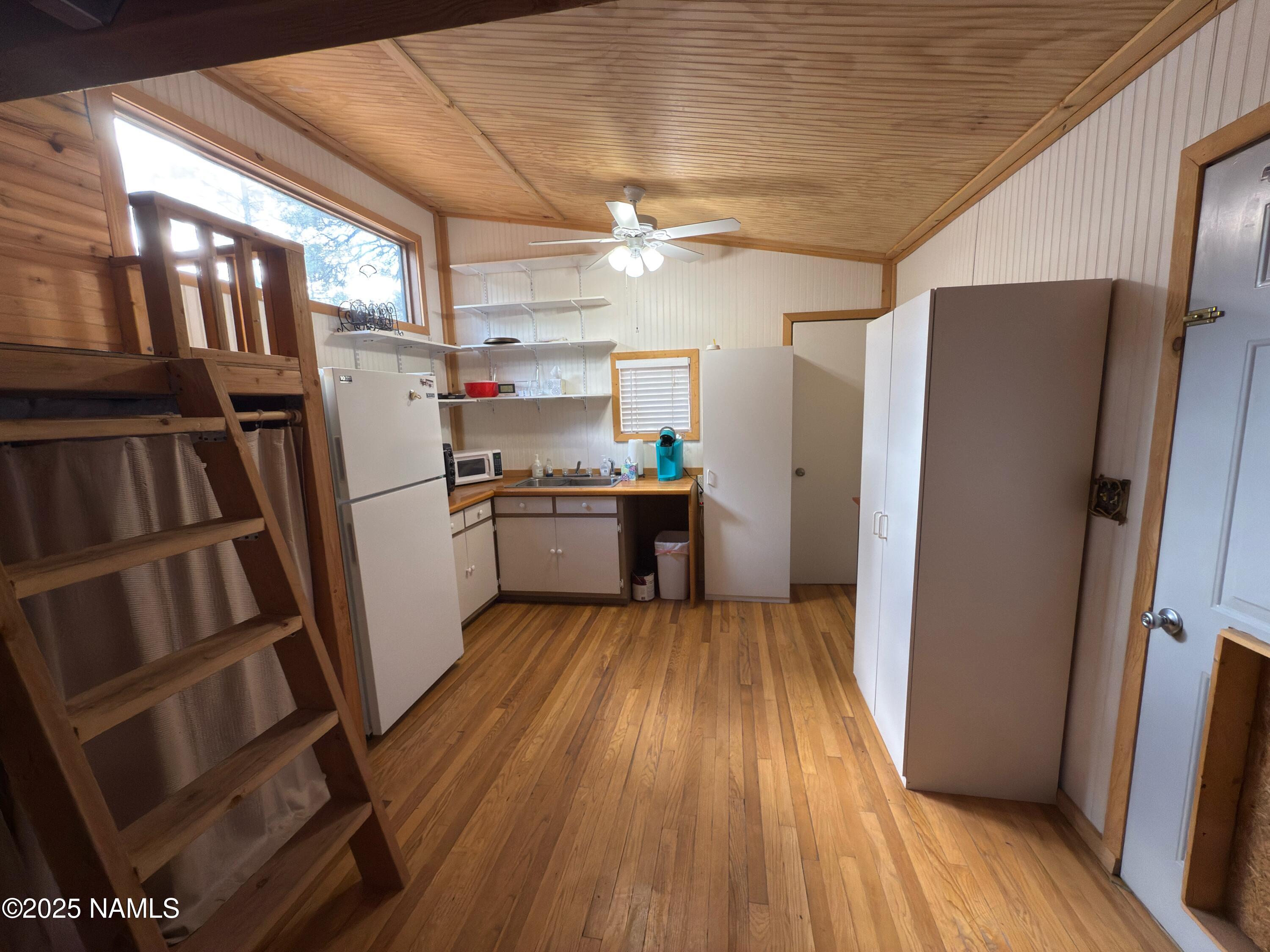 7261 East Long Bow Drive Williams, AZ 86046 - Photo 19 of 43 a kitchen with wooden floors and stainless steel appliances